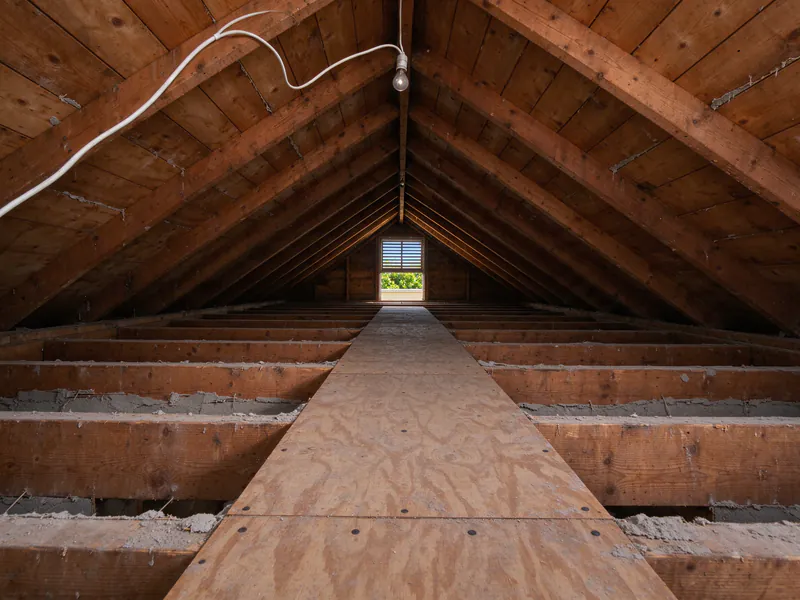 Before: bare ceiling joists in a Los Angeles bungalow attic with no insulation